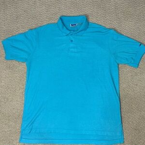 Vintage 1980s Levi's Men's Polo in a classic blue. Large.
